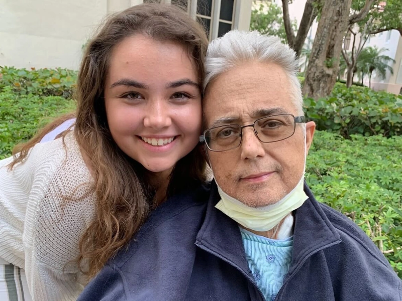 young woman smiling next to adult man