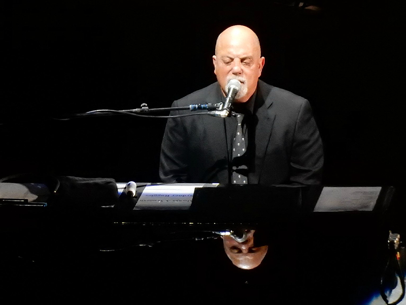 man singing and playing the piano