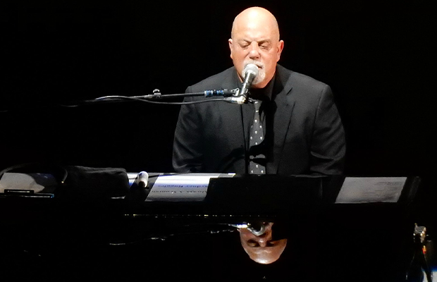 man singing and playing the piano