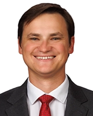 Close-up of a man wearing a suit.