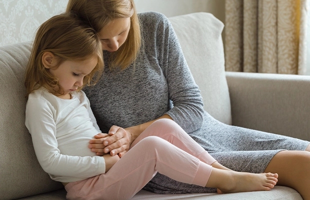 woman pampering her little daughter