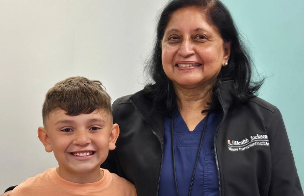 smiling child next to a woman