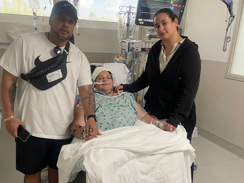 A man and a woman next to a woman in a wheelchair