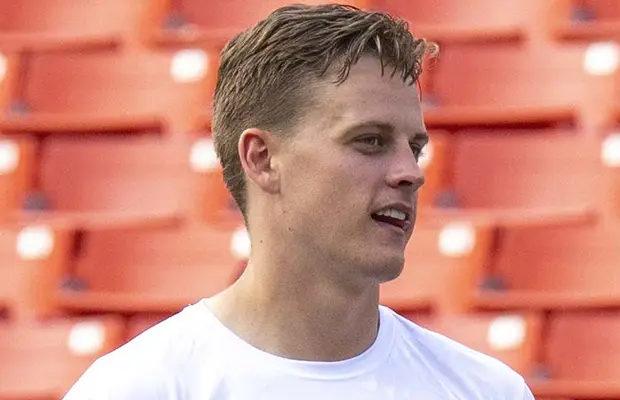 A closeup of a man, there are stadium seats behind him