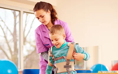 A woman helping a young child walk