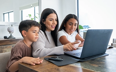 A mother and her children checking the computer