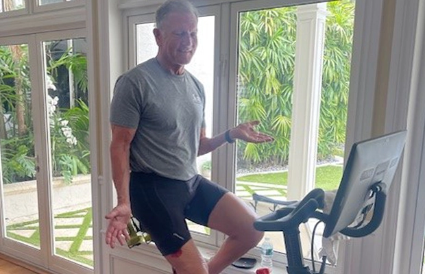 A person standing on a exercise bike
