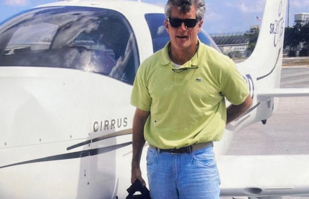 A person standing in front of a plane