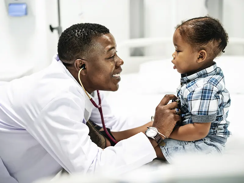 Doctor examining a girl in her office