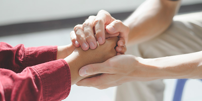 A closeup of a person holding another persons hands