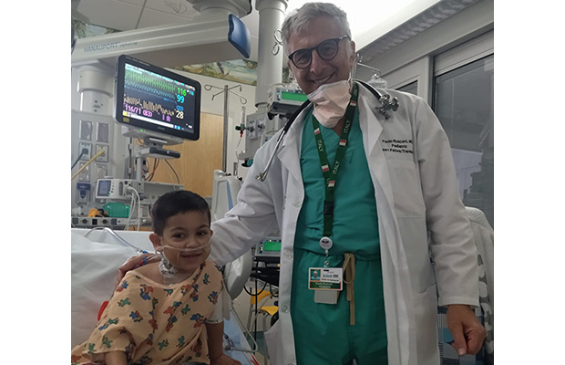 A medical professional and young patient within a medical room