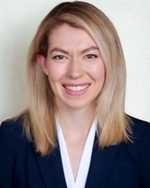 Close-up of a blonde woman smiling at the camera.