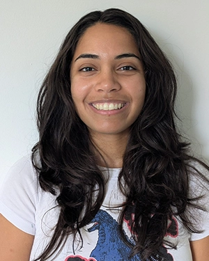 Close-up of a woman wearing a T-shirt, smiling at the camera.