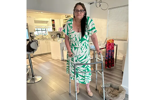 Photograph of a woman using a walking stick