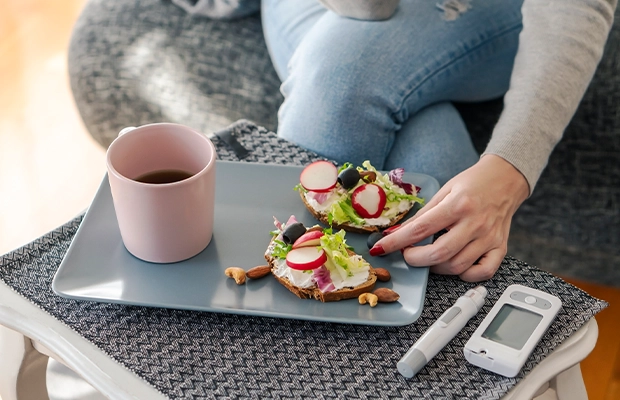 Close-up of a woman's hands picking up some salad toast