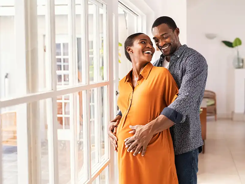 man hugging pregnant woman