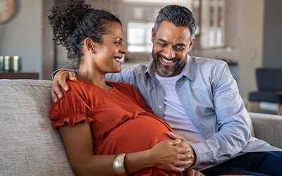 man smiling with his pregnant partner