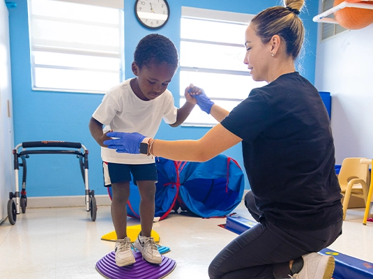 Boy doing therapy with nurse