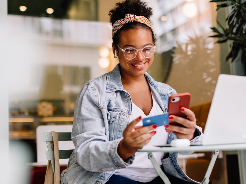 woman registering a card on her cell phone