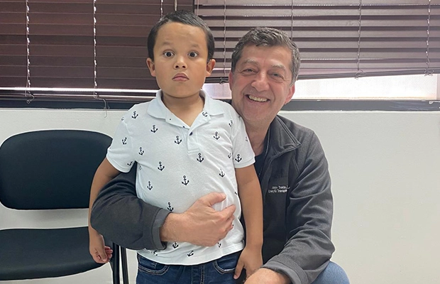 boy next to his father
