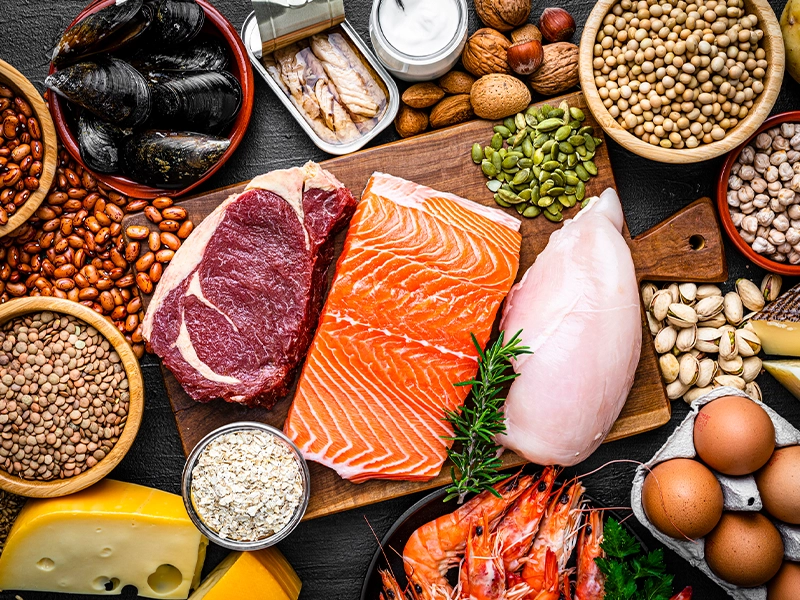Image of a table full of food such as salmon, grains, meats, among others