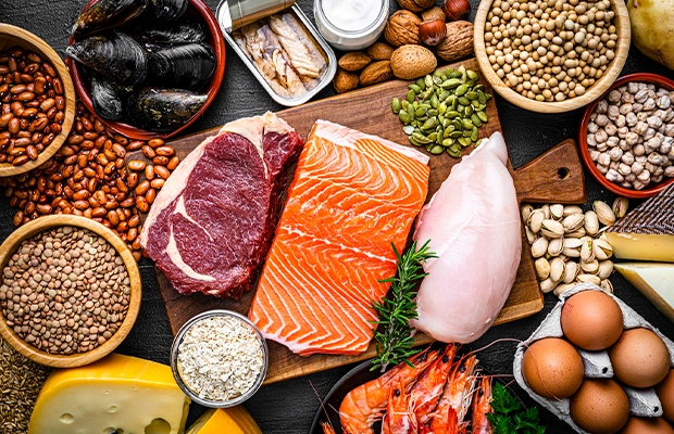 Image of a table full of food such as salmon, grains, meats, among others