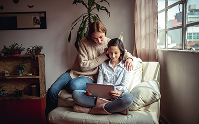 mom and daughter checking information on a laptop