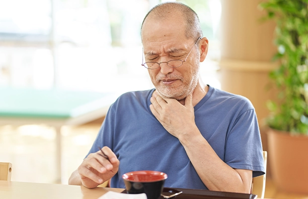elderly man suffering from throat pain