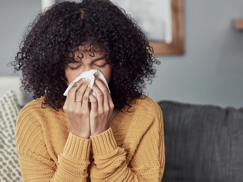 woman blowing her nose