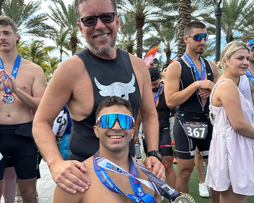 man showing medal he won in wheelchair competition