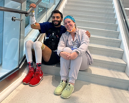 man and woman sitting on stairs posing at camera