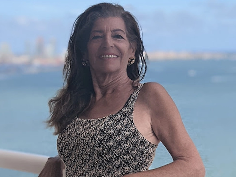 Close-up of woman posing by the sea from a balcony