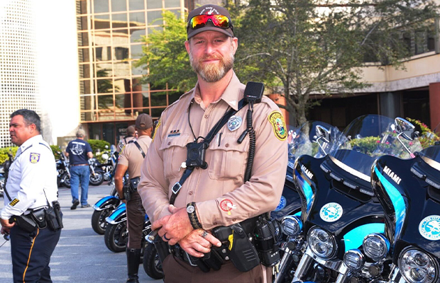 close up of policeman smiling and posing to the camera