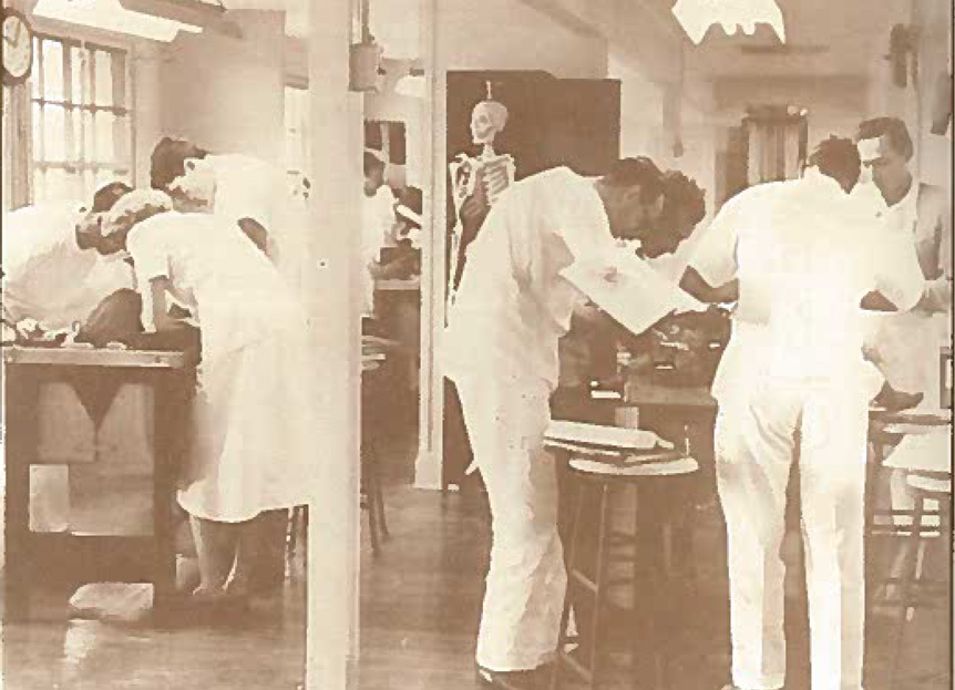 Black and white image of physicians and nurses in a hospital room