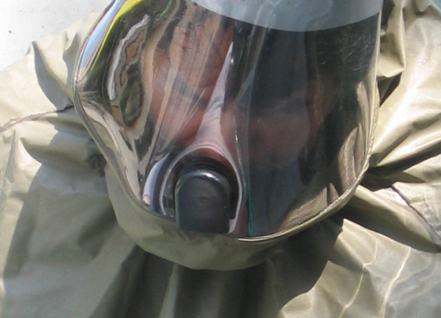 A closeup of a person wearing a hazmat suit