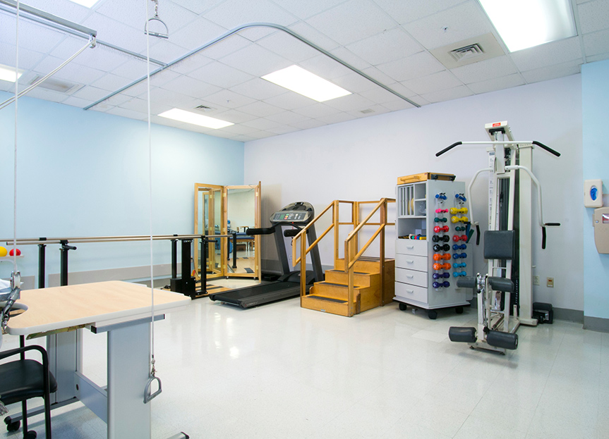A rehabilitation room filled with tools and machines to help a person rehabilitate