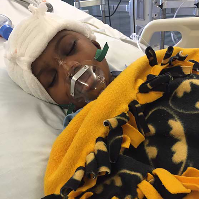 Darnal Mundy sleeping with a respirator on a hospital bed