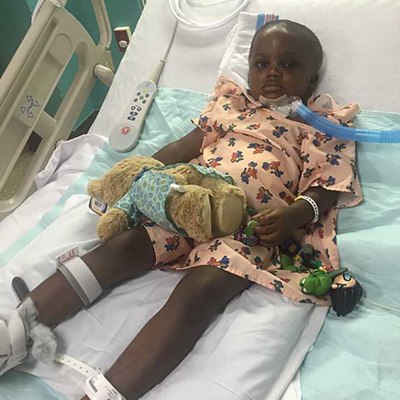 Darnal Mundy laying on a hospital bed