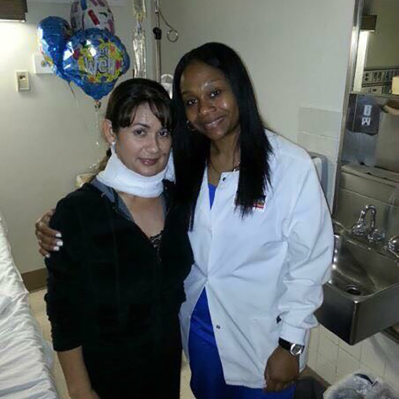 Evelin Matamoros with a bandage around her neck, she stands next to her physician who is wearing a white coat