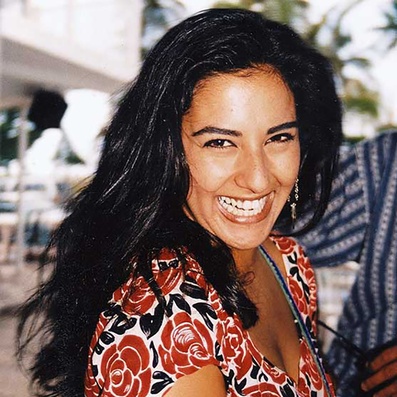 Feride Buch smiling, she's wearing a flower pattern dress