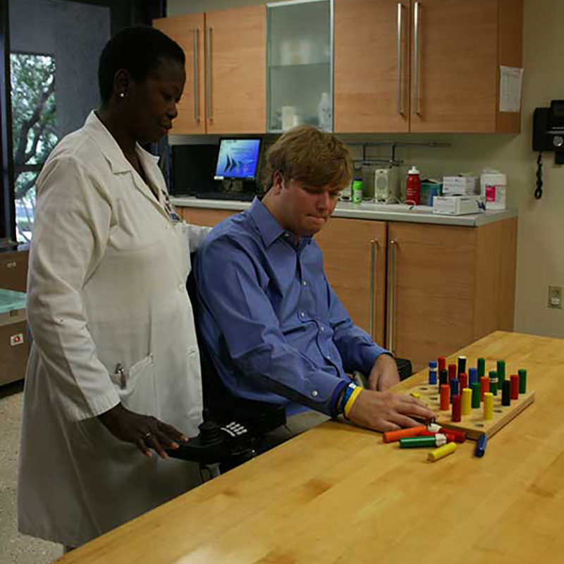 Woody during a therapy session, he is sitting next to a physician
