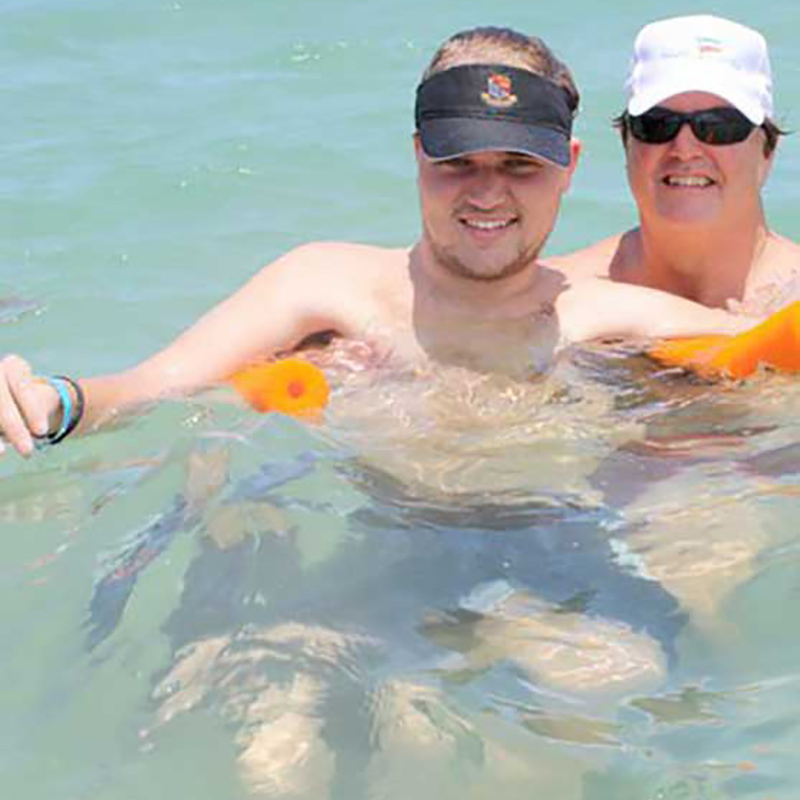 Woody floating in water with the help of another person
