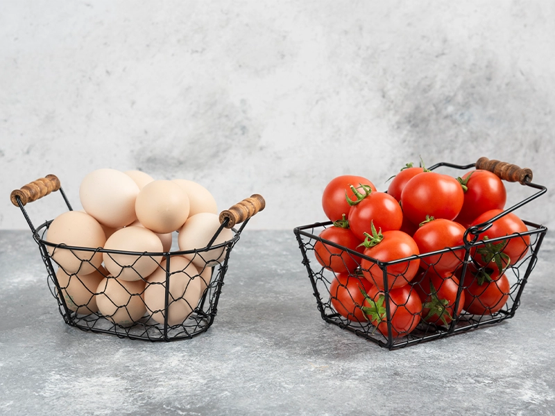 metal baskets full of eggs and tomatoes