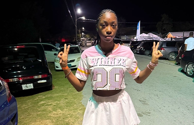 Teenager in cheerleader outfit posing for the camera