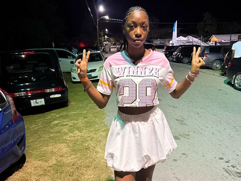 Teenager in cheerleader outfit posing for the camera