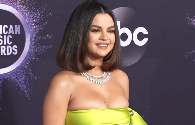 photograph of selena gomez during event wearing lemon green dress