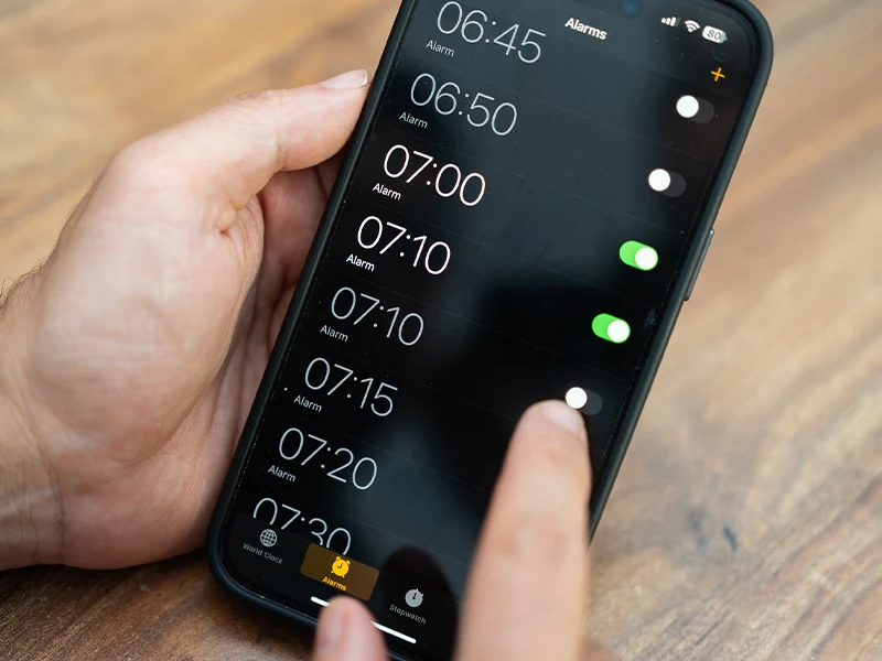close-up of a hand manipulating a cell phone