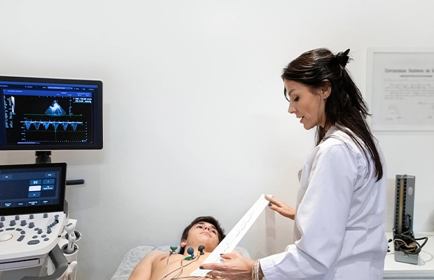 Doctor examining a child on the exam table in her office.