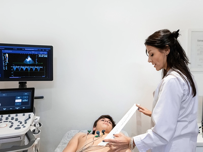 Doctor examining a child on the exam table in her office.