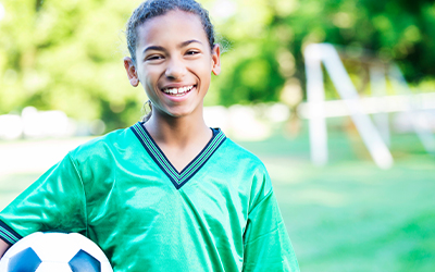 girl holding soccer ball